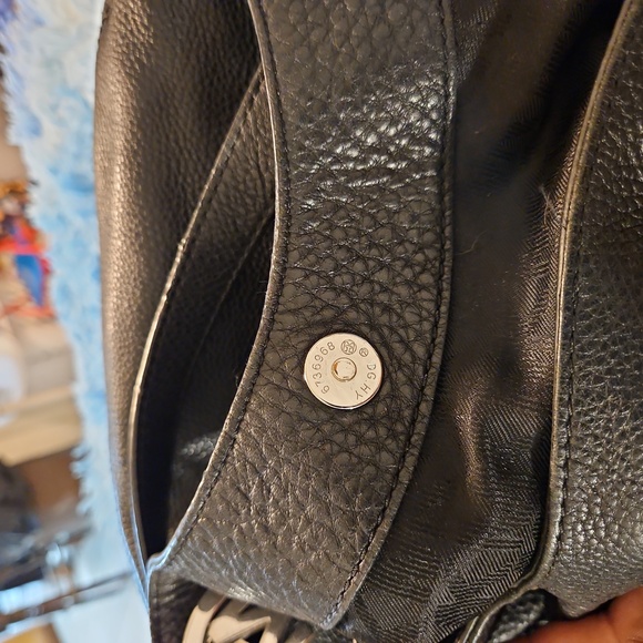 Micheal Kors satchel black all leather gold emblem accent.  It's roomy and nice. - Picture 5 of 8